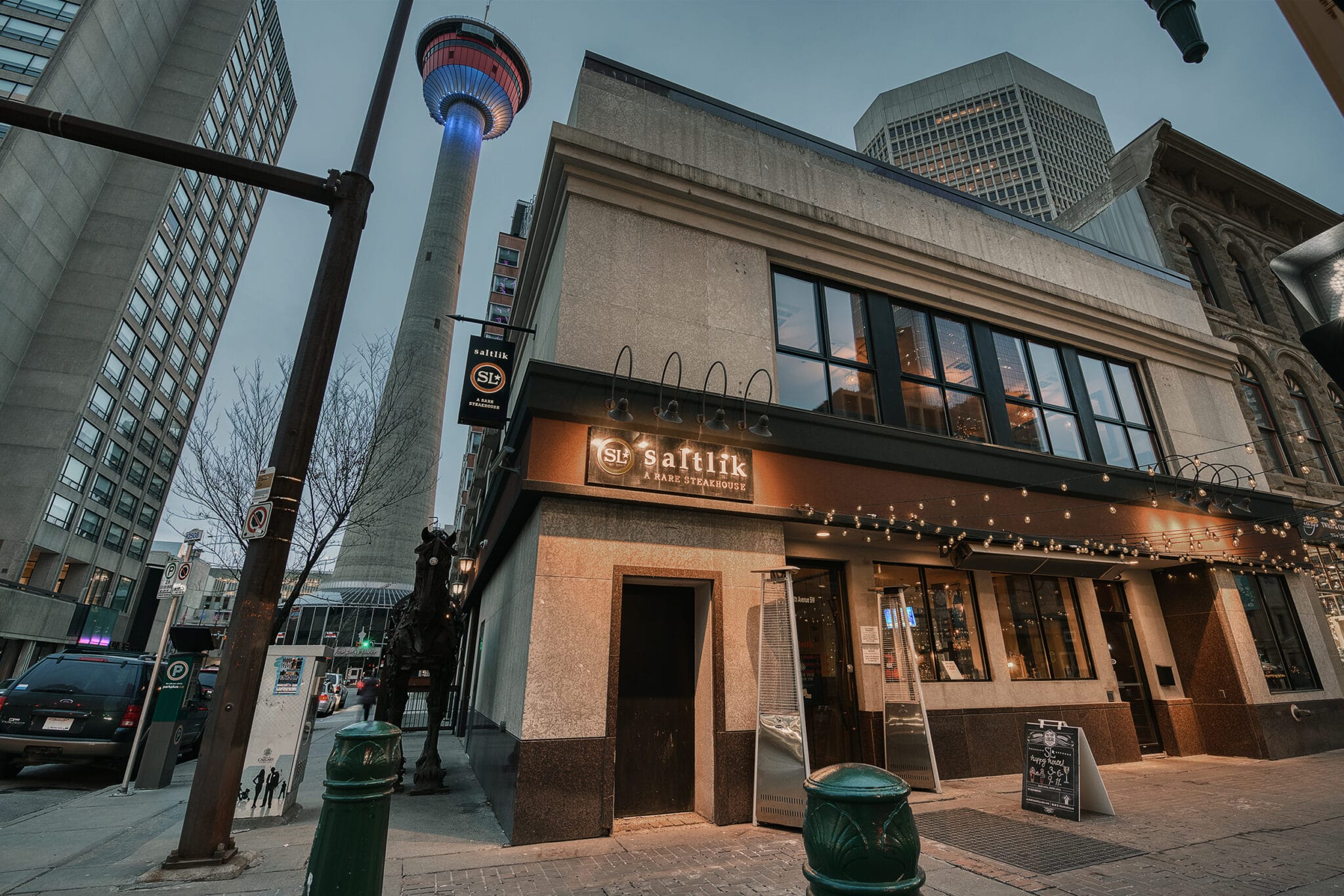 A photograph of the exterior of the Saltlik Restaurant in Calgary with the Calgary Tower visible in the background.