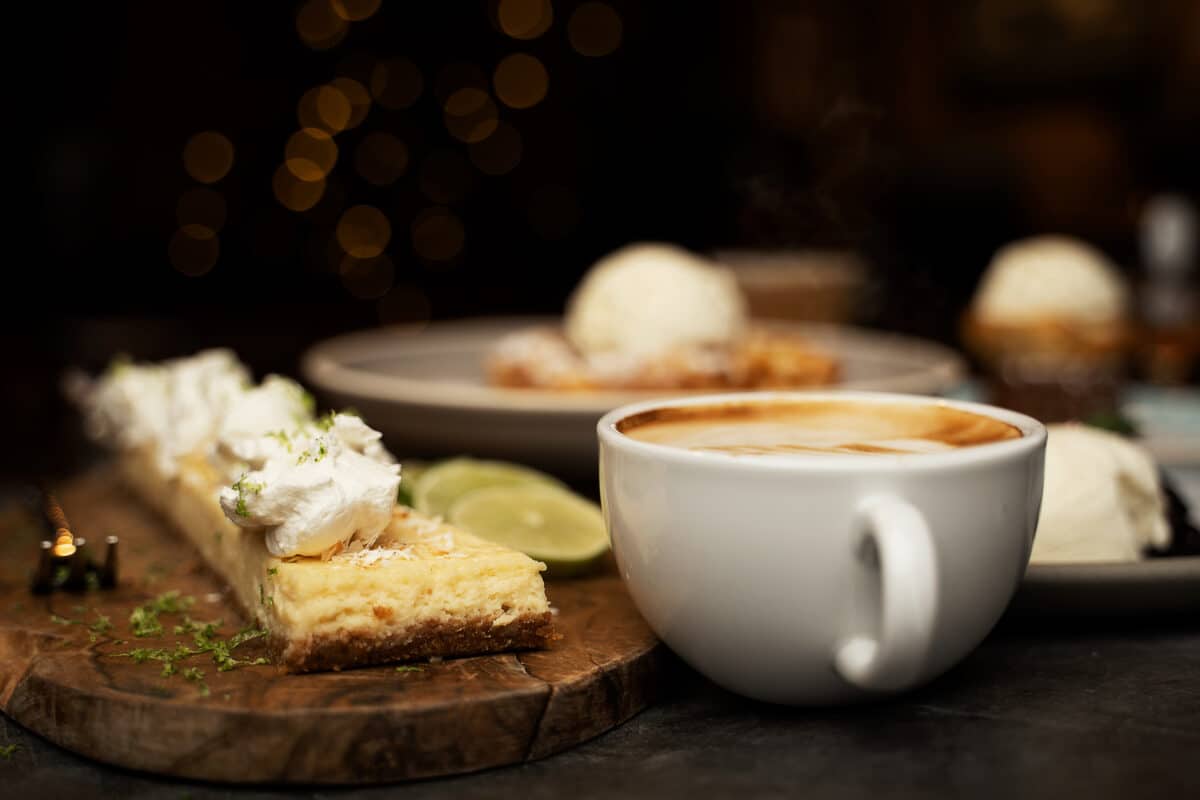 Key Lime Pie and a Cappuccino, with other dessertes visible in the blurred out background