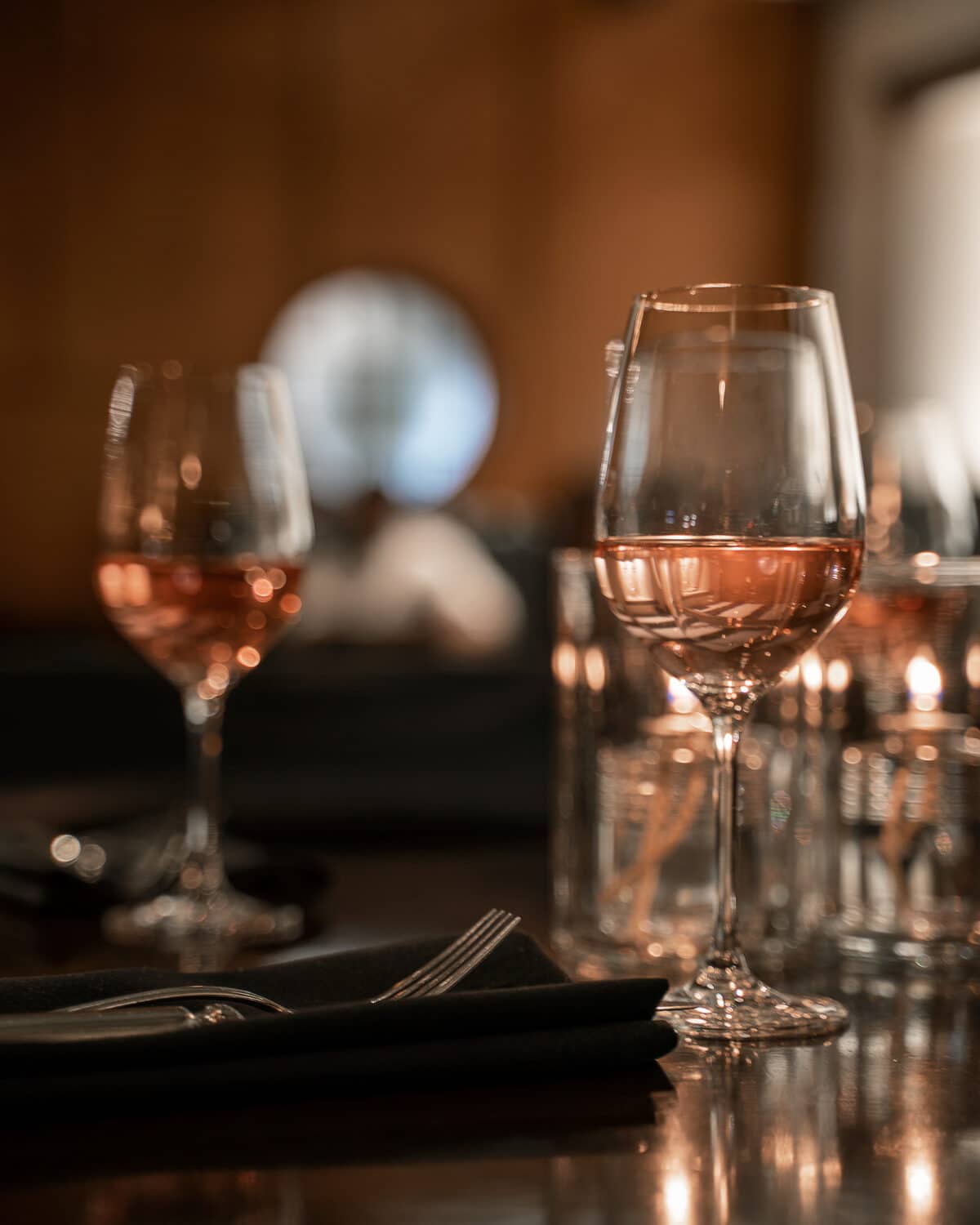 From the Saltlik Event space, two glasses of water on a set table, awaiting guests