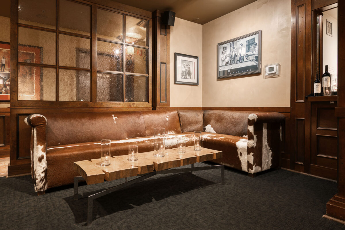 An L-shaped bull skin couch located in a corner of the event location in Calgary