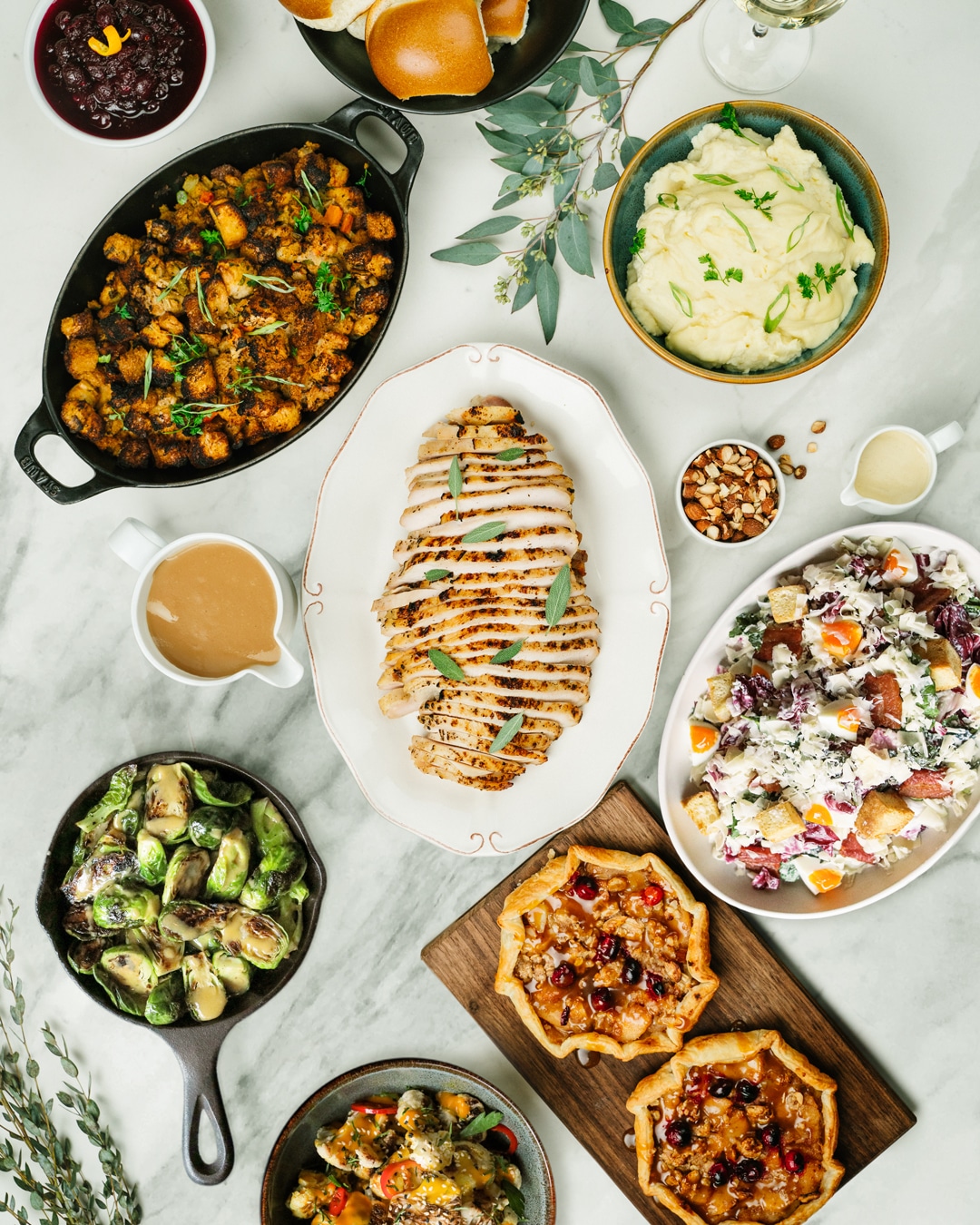 Saltlik's Thanksgiving take out menu viewed from above, artfully plated on a white marble surface.